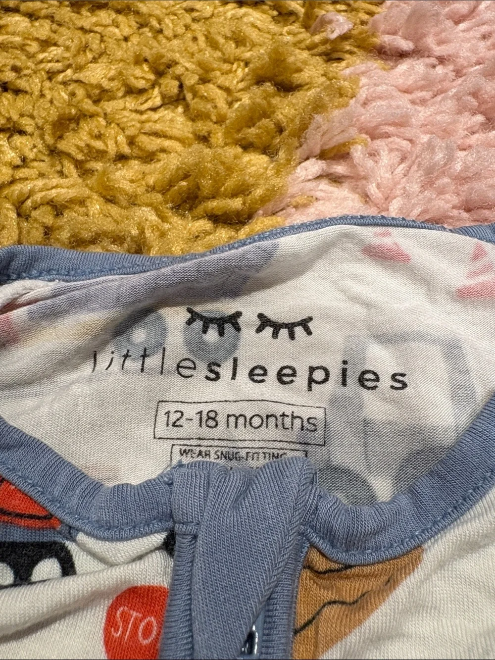 Little Sleepies White One-Piece Footie with Multicolor Truck Print and Blue Trim